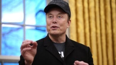 Elon Musk, wearing a Make America Great Again hat, speaks in the White House.