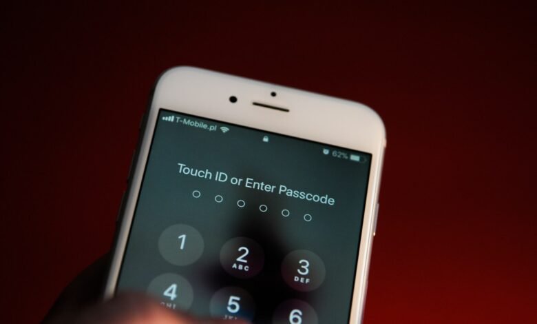 Close-up of an iPhone screen displaying a passcode entry prompt, with a finger about to input a number.