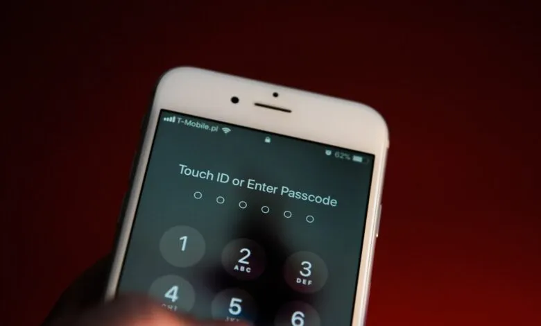 Close-up of an iPhone screen displaying a passcode entry prompt, with a finger about to input a number.