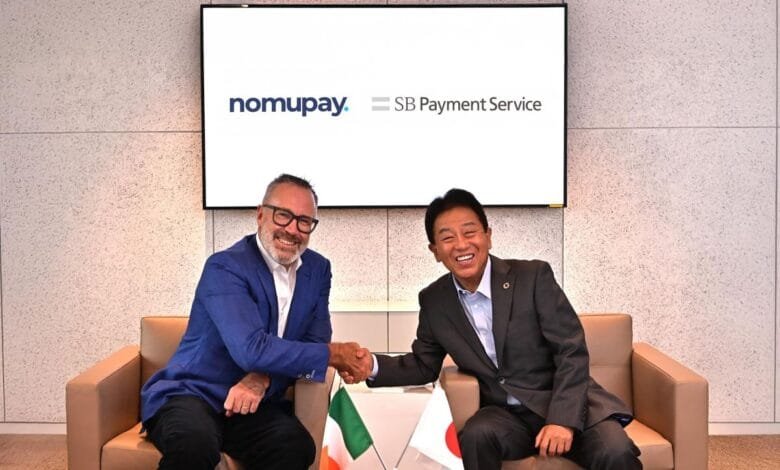 Peter Burridge and Jun Shimba shake hands; Nomupay and SB Payment Service logos displayed.
