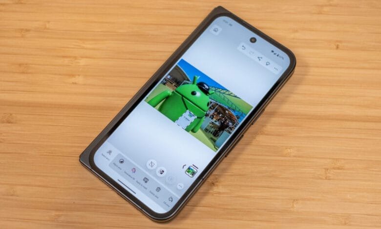 Smartphone displaying a photo editing app with a large green Android mascot in the image.