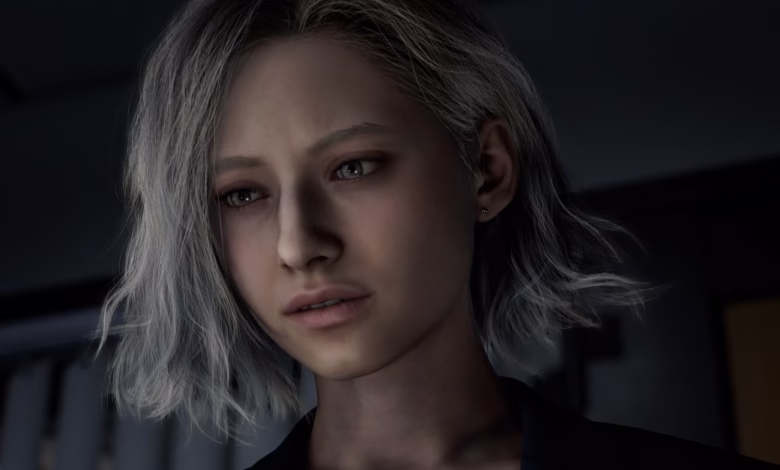 Close-up of a young woman with short, gray hair, wearing a dark jacket, looking pensive.