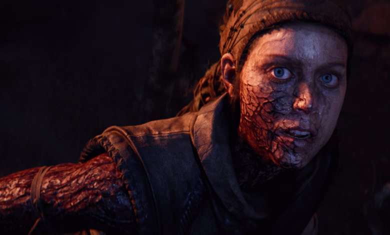 Close-up of a woman's face, severely burned and scarred, showing intense fear and distress. Dark, dramatic lighting.