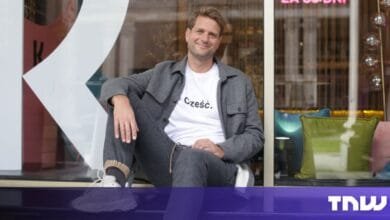 Sebastian Siemiatkowski, Klarna’s CEO, sits casually on a windowsill, wearing a gray jacket and white t-shirt with Polish writing. He smiles at the camera.