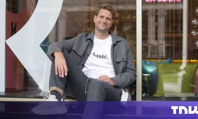 Sebastian Siemiatkowski, Klarna CEO, smiles casually while sitting on a windowsill.
