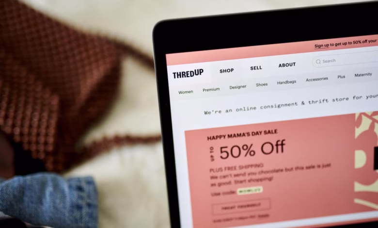 Close-up of a laptop screen displaying the ThredUp website, showcasing a Mother's Day sale with up to 50% off.