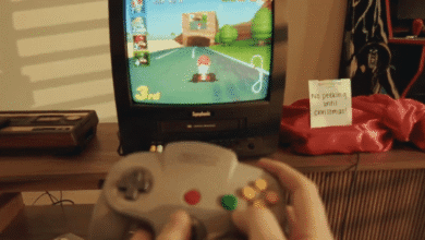 A person plays a racing game on a Nintendo 64, a Christmas gift still unopened nearby.