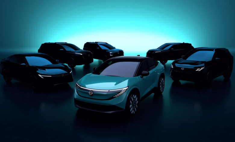 A teal electric car is prominently displayed, surrounded by several other dark-colored electric vehicles in a sleek, futuristic setting.
