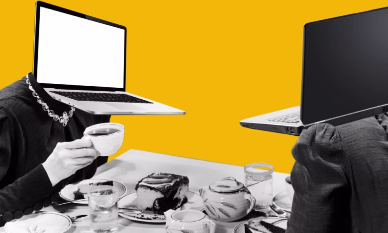Two figures with laptops for heads sit at a table, enjoying tea and cake. A surreal, humorous image.