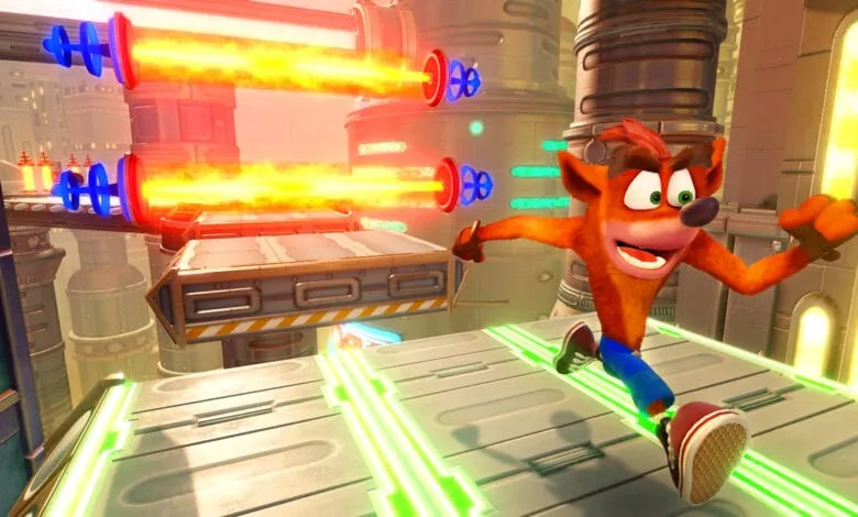 Crash Bandicoot runs across a futuristic platform, dodging bright orange energy beams. The scene is vibrant and action-packed.