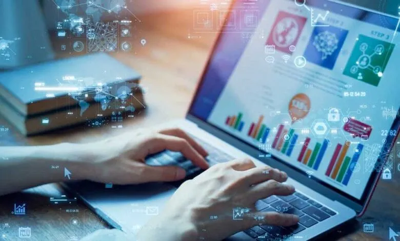 Hands typing on a laptop displaying colorful data charts and graphs overlaid with digital icons and network connections.