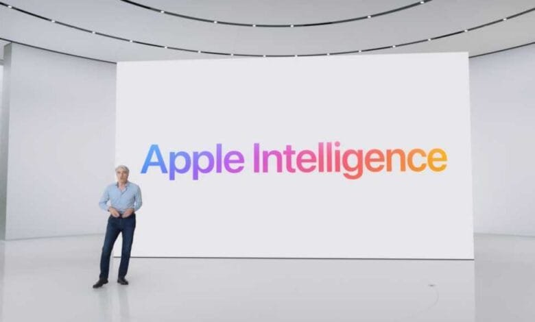 A man stands on a stage in front of a large screen displaying the Apple Intelligence logo.