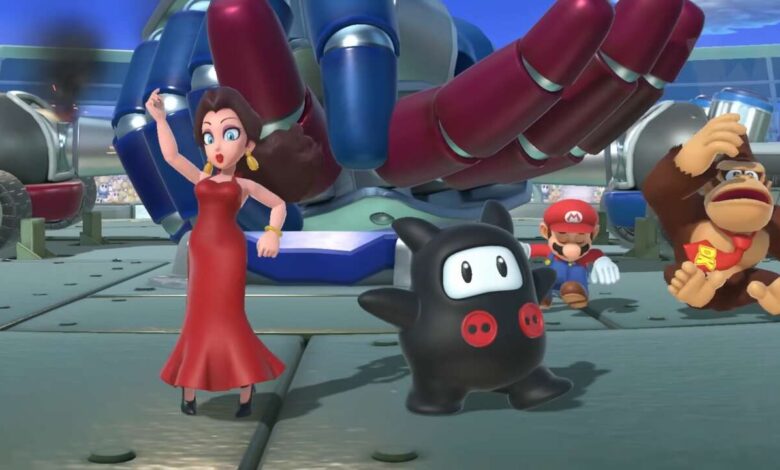 Mario characters, including Princess Daisy in a red dress, Mario, Donkey Kong, and a black ninja-like creature, pose near a large robotic arm.