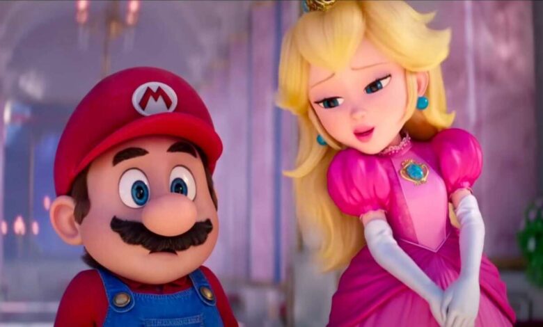 Mario and Princess Peach from the Super Mario Bros. Movie stand close together, Peach looking coyly at Mario.