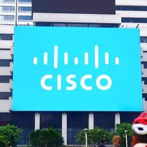 Large Cisco logo displayed on a bright blue billboard attached to a city building.