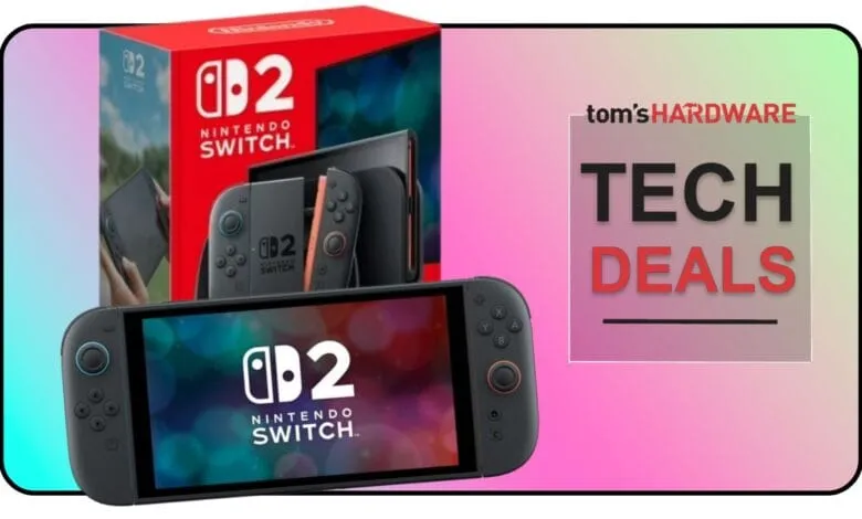 Nintendo Switch OLED model with gray and coral joy-cons next to its box; Tom's Hardware Tech Deals banner in background.