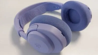 Pair of lavender-colored headphones with soft earcups, resting on a white surface.