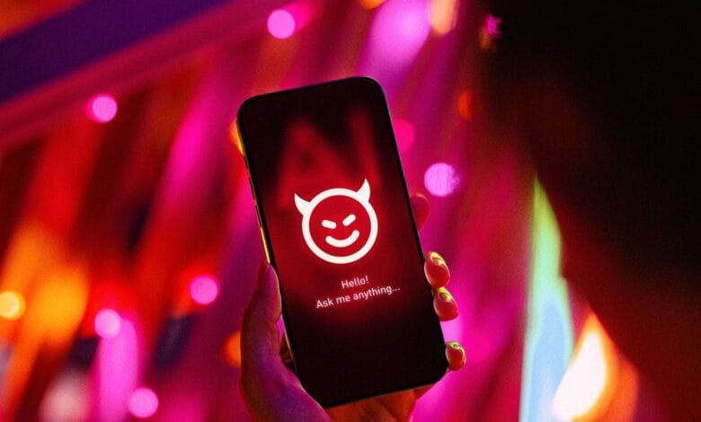 A hand holds a phone displaying a devilish emoticon and the text 'Hello! Ask me anything...', set against a vibrant pink and orange bokeh background.
