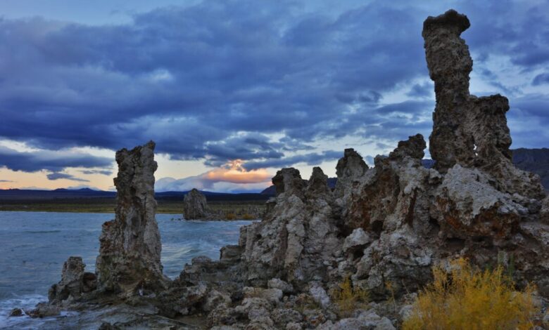 Mono Lake's tufa towers at sunset, dramatic clouds fill the sky.