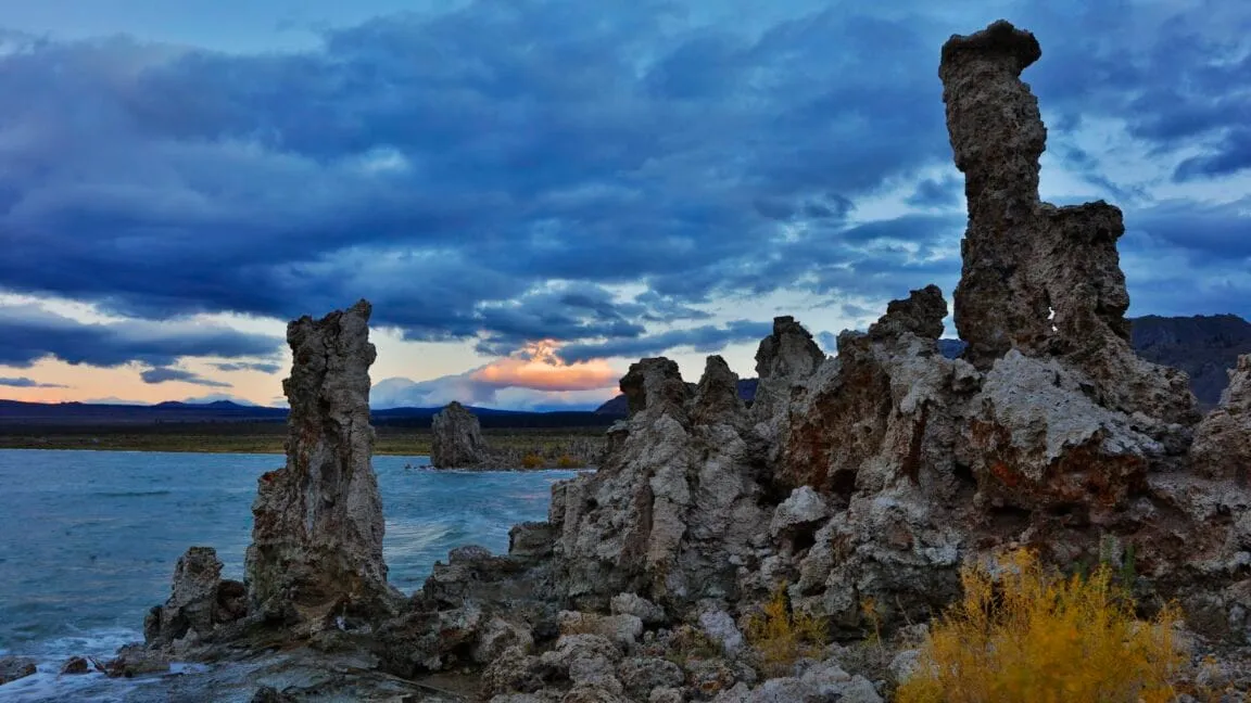 Mono Lake's tufa towers at sunset, dramatic clouds fill the sky.