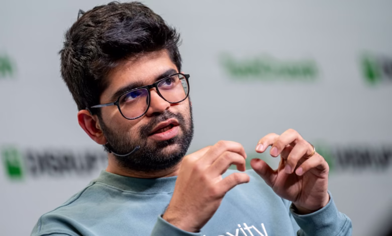 Aravind Srinivas, CEO of Perplexity AI, speaks at TechCrunch Disrupt, gesturing with his hands.