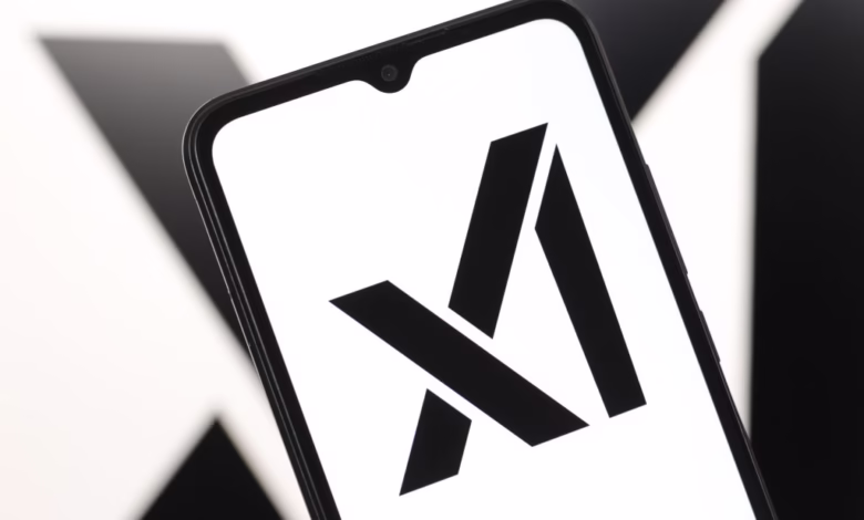 Close-up of a smartphone displaying the xAI logo, a stylized black 'X' on a white background.