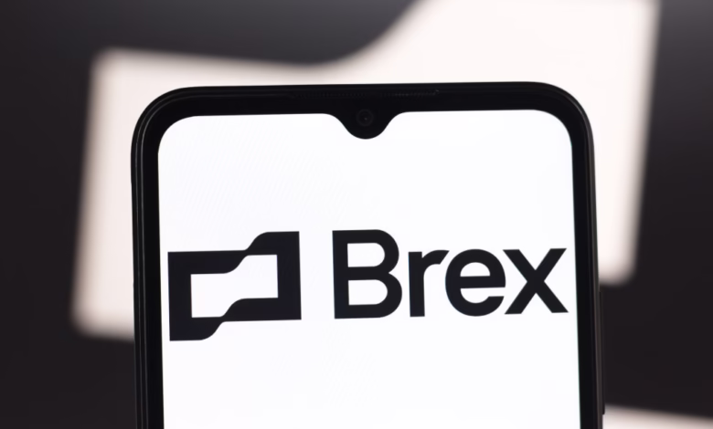 Close-up of a smartphone displaying the Brex logo on a white screen.
