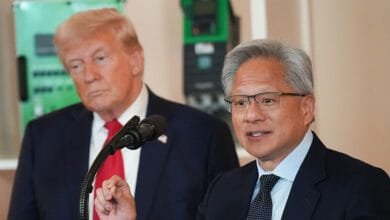 Jensen Huang, CEO of Nvidia, speaks at a White House event with President Donald Trump in the background.