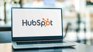 HubSpot logo displayed on a laptop screen in a blurred background.