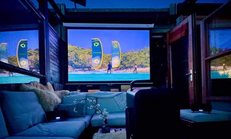 Outdoor home theater showing kitesurfers on a tropical beach. Relaxing evening ambiance.