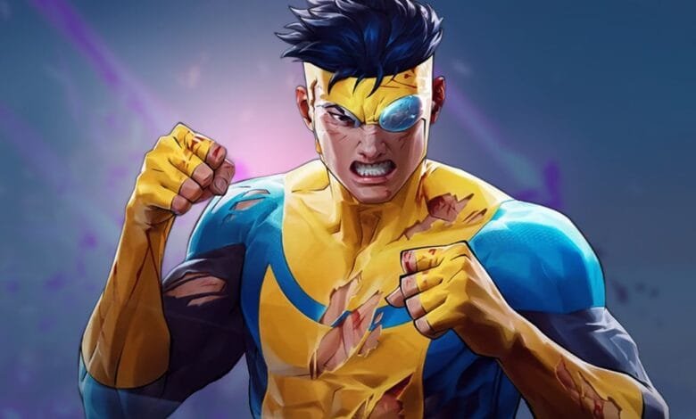 Invincible, a superhero with a torn, yellow and blue costume, stands defiantly, fists clenched. He has a determined expression and an eyepatch.