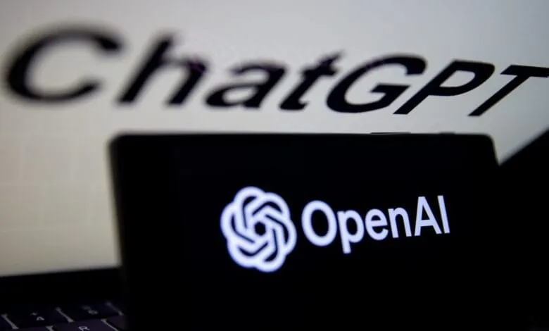 OpenAI logo on a device with a blurred ChatGPT background.