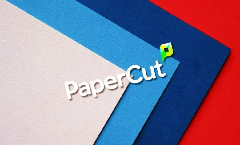 PaperCut logo on layered pastel pink, blue, and dark blue paper against a red background.