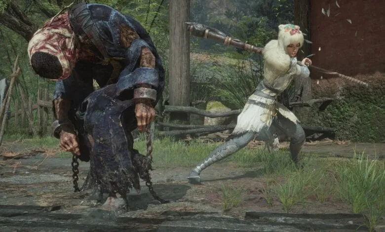 A female warrior in a white and grey outfit wields a large club, standing over a chained, injured figure in a dark robe.