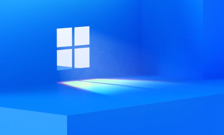Abstract image of a Windows logo-shaped window in a bright blue room, casting rainbow-hued light.