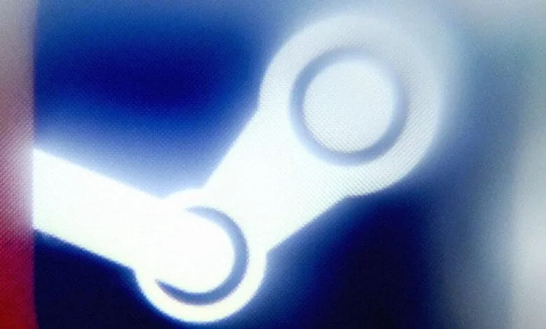 Close-up of the Steam logo on a screen, slightly blurred, with blue and white tones.