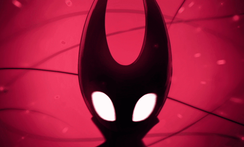 Close-up of the Knight's mask from Hollow Knight, glowing white against a dark red background with shadowy lines.