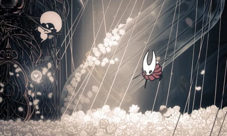 Knight from Hollow Knight video game leaps across a field of white roses, guided by strings, towards an ornate structure.