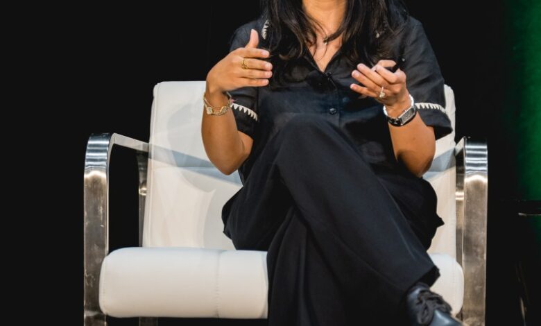 Ahanvi Sardana, entrepreneur, sits in a white chair, speaking engagingly at a conference.
