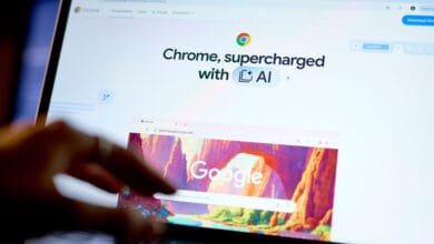 Close-up of a laptop screen displaying the Google Chrome browser, showcasing its AI-powered features. A hand interacts with the screen.