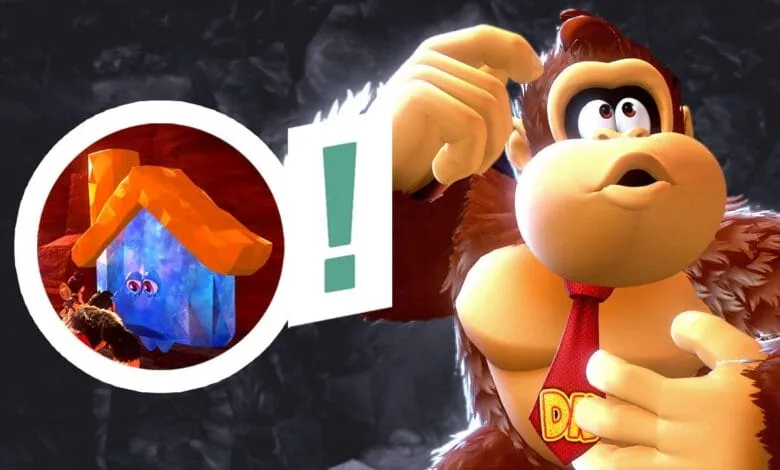 Donkey Kong, wearing a tie, looks puzzled at a small, glowing blue house. An exclamation point emphasizes the mystery.