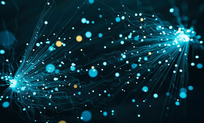 Abstract artwork featuring teal and gold glowing particles connected by thin lines, creating a dynamic, energetic visual.