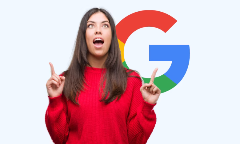 Woman in red sweater points upward with both index fingers, surprised expression, large Google logo behind her.