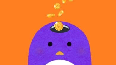 Purple penguin with a hole on its head where gold coins with dollar signs are falling into.