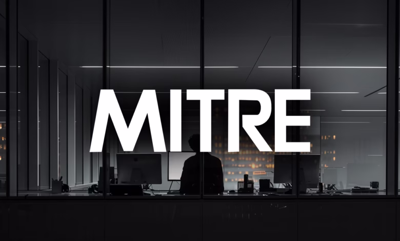 MITRE logo superimposed on a nighttime office scene, a person sits at a computer.
