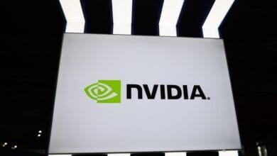 NVIDIA logo displayed on a large white sign, set against a dark background with illuminated stripes above.