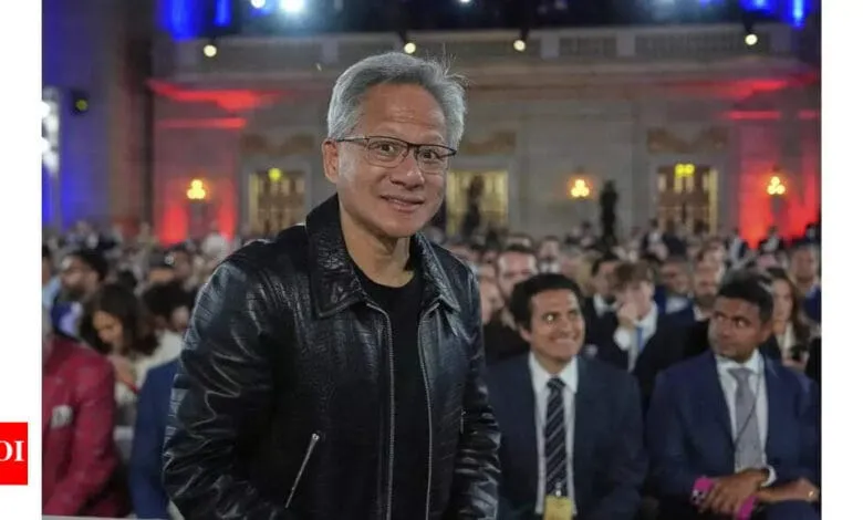 Jack Ma, founder of Alibaba, smiles at a large event, wearing a black leather jacket.