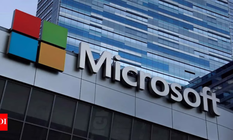 Microsoft logo and building exterior. Modern architecture with blue glass panels.