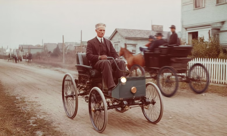 Henry Ford in his Quadricycle, a three-wheeled automobile, on a dirt road, with a horse-drawn carriage passing by.