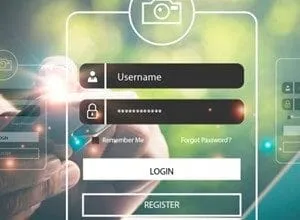 Close-up of hands holding a smartphone, logging into an account on a digital interface with username and password fields.